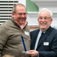 Dr. Stabler smiling at podium